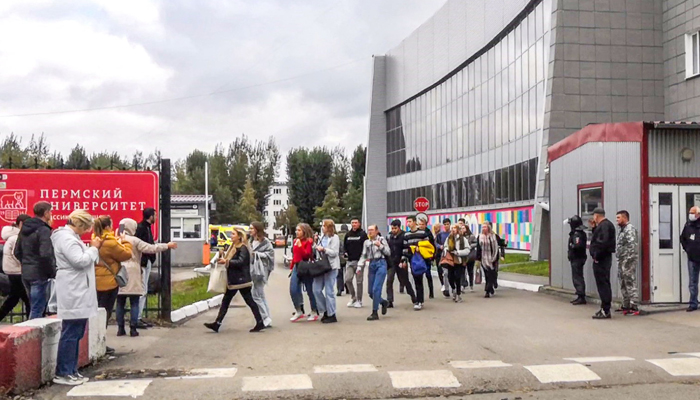 Students evacuate a building of the Perm university campus in Perm on September 20, 2021 following a shooting. — AFP