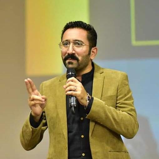 Tanzeel Rauf gestures while speaking.