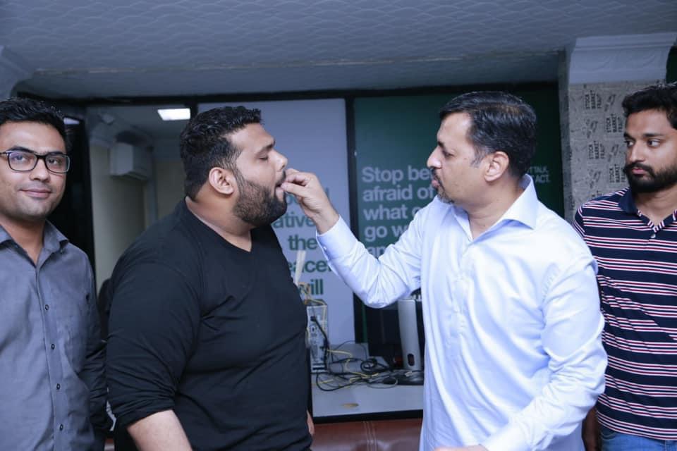 Mustafa Kamal feeds sweets to Nadir Qureshi.