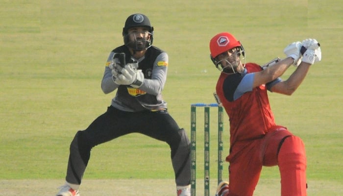 Haider Ali smashes a ball for six while the wicketkeeper looks on. — File photo