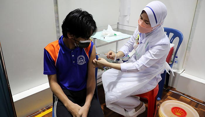 A secondary school student receives a dose of the Pfizer vaccine against the coronavirus disease (COVID-19) at a school, in Putrajaya, Malaysia, September 20, 2021. — Reuters