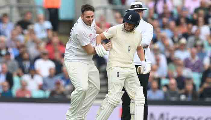 Pitch invader, YouTuber Daniel Jarvis, known as ´Jarvo 69´ collides whith England´s Jonny Bairstow (R) as he delays play on the second day of the fourth cricket Test match between England and India at the Oval cricket ground in London on September 3, 2021.-AFP