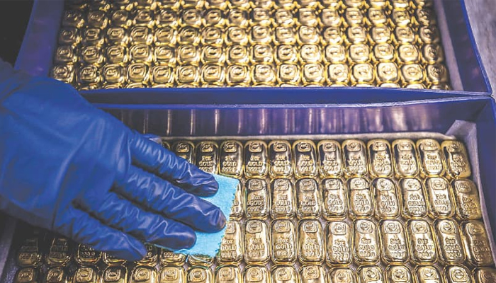 A worker polishes gold bars. — AFP/File