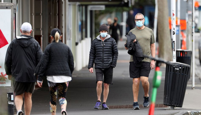 People wear masks while stepping outside during a lockdown to curb the spread of a coronavirus disease outbreak, in Auckland. — Reuters/File