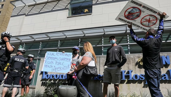 Protesters hold signs during an anti-vaccine mandate protest outside Toronto General Hospital in Toronto, Ontario, Canada September 13, 2021. — Reuters/File