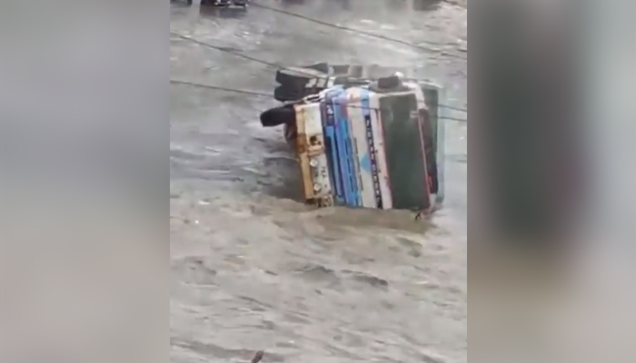 A truck upturns in Karachis Nagan area as rains lashed the port city, on September 23, 2021. — Twitter/NKMalazai