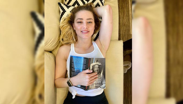 Amber Heard enjoys reading Pablo Neruda book as Johnny Depp condemns cancel culture