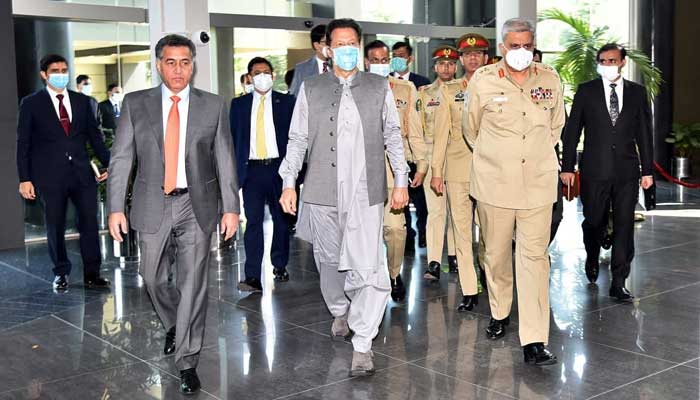 Prime Minister Imran Khan (C) and Chief of Army Staff General Qamar Javed Bajwa received by Director General Inter Services Intelligence Lieutenant General Faiz Hamid, at the ISI Secretariat, on September 24, 2021. — Photo courtesy Prime Ministers Office