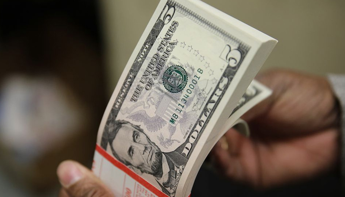 A packet of former US President Abraham Lincoln five-dollar bill currency is inspected at the Bureau of Engraving and Printing in Washington March 26, 2015. — Reuters/File