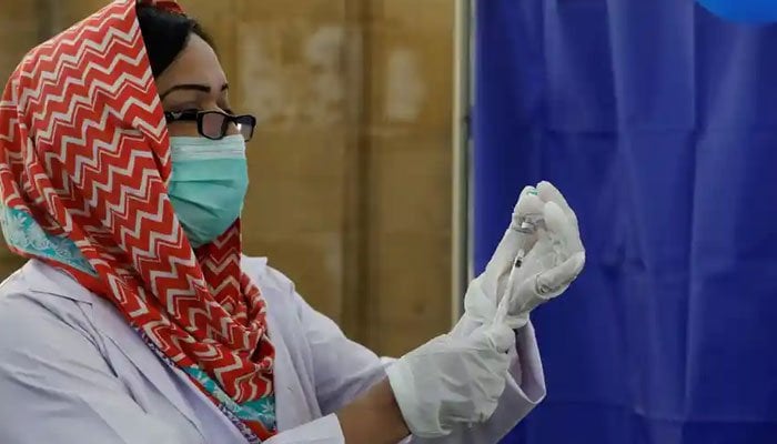 A nurse preparing to administer a COVID-19 shot in Pakistan. Photo: AFP