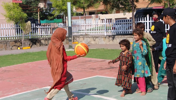 Some out-of-school children can be seen playing basketball. — Photo by author