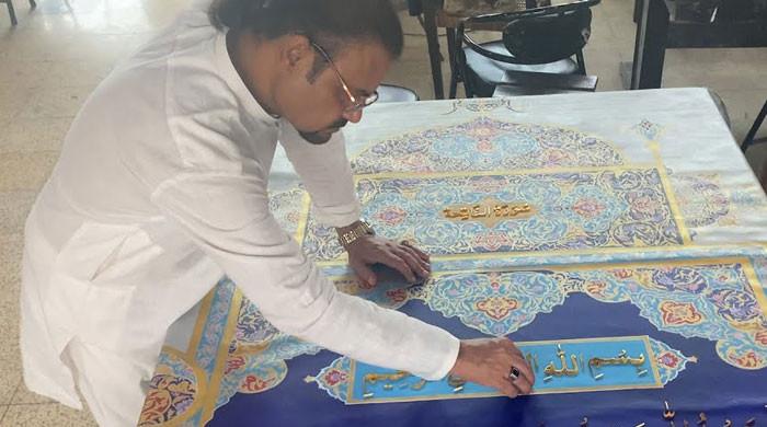 Pakistani artist making world’s largest Holy Quran with 200kg gold-plated words