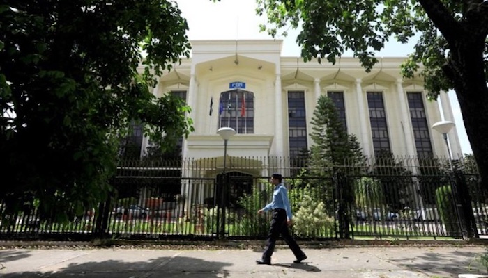 A policeman walks past the Federal Board of Revenue office building in Islamabad. Photo: Reuters