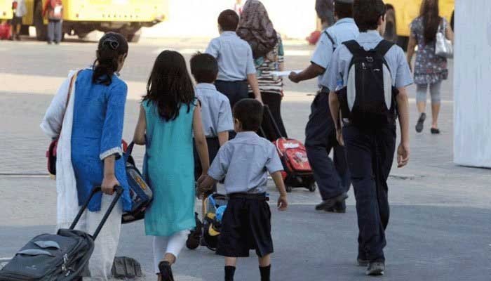 Schoolchildren walking to school carrying heavy school bags. Photo: File