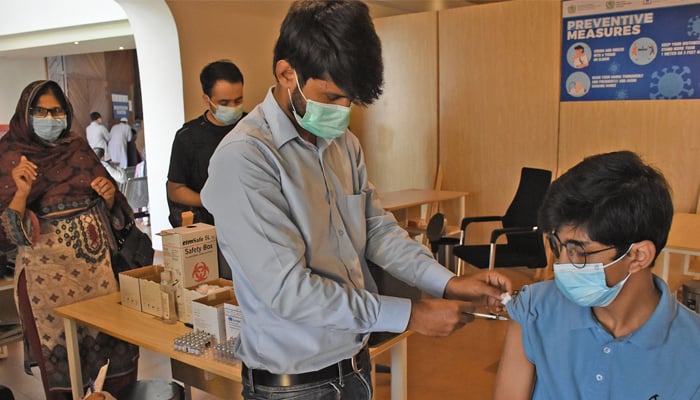 A teenager receives vaccine at a vaccination center at F-9 Park in Islamabad, on September 18, 2021. — Online/File