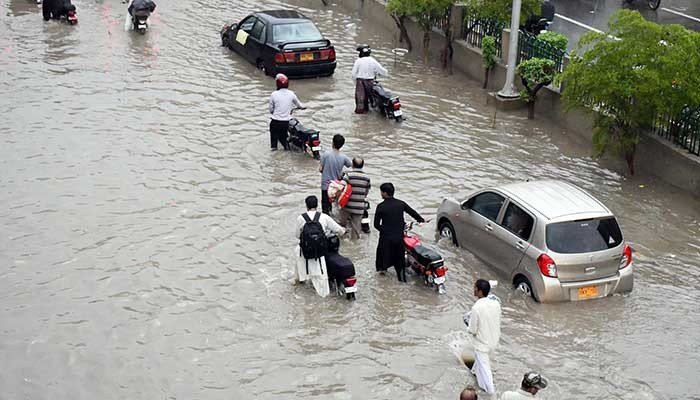 Motorists facing troubles due to rainy water accumulated on Shahr-e-Faisal as after the heavy rainy weather in provincial capital. Photo: Sabir Mazhar.