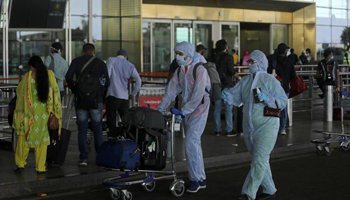 Passengers wearing personal protective equipment (PPE) enter Chhatrapati Shivaji International Airport in Mumbai, India, on May 25, 2020. — Reuters/File