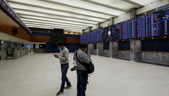 Two people can be seen standing in the main hall of the Pakistan Stock Exchange. — Reuters/File