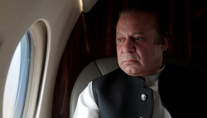 Former prime minister Nawaz Sharif looks out the window of his plane after attending a ceremony to inaugurate the M9 motorway between Karachi and Hyderabad, Pakistan February 3, 2017. — Reuters/File