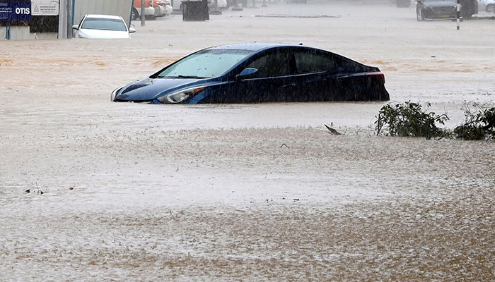A car is partially submerged on a flooded street as Cyclone Shaheen makes landfall in Muscat Oman, October 3, 2021. — Reuters/File