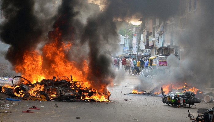 Vehicles were set on fire by a mob during a clash in India. — Reuters/File