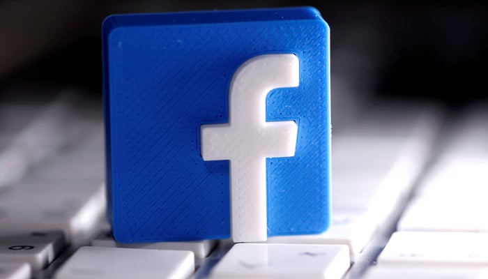 A 3D-printed Facebook logo is seen placed on a keyboard in this illustration taken March 25, 2020. REUTERS