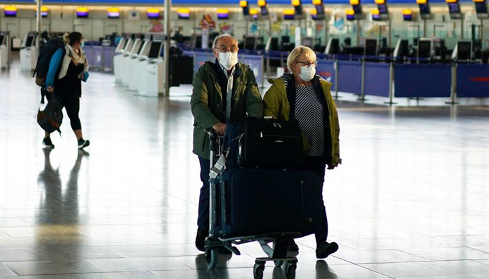 People wearing masks are seen at the London Heathrow Airport in April 2020 as the spread of the coronavirus disease (COVID-19) continues. — Reuters/File