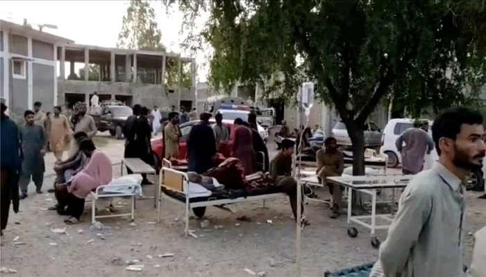 People gather outside a hospital following an earthquake in Harnai, Balochistan, Pakistan, October 7, 2021, in this still image obtained from video. Courtesy of QuettaVoice.com / Social Media via Reuters