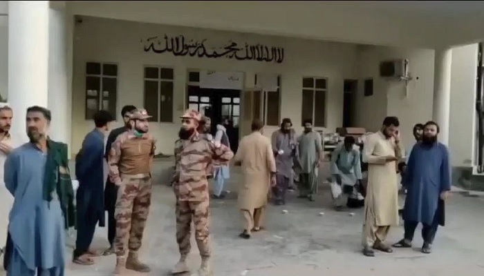 People gather outside a hospital following an earthquake in Harnai, Balochistan, Pakistan, October 7, 2021, in this still image obtained from video. Courtesy of QuettaVoice.com / Social Media via REUTERS
