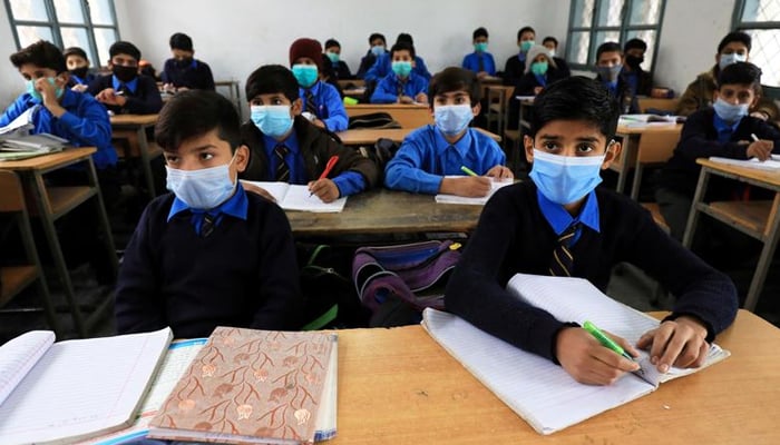 Students wear protective masks as they attend a class at school as the outbreak of coronavirus disease (COVID-19) continues, in Peshawar, Pakistan November 23, 2020. — Reuters/File