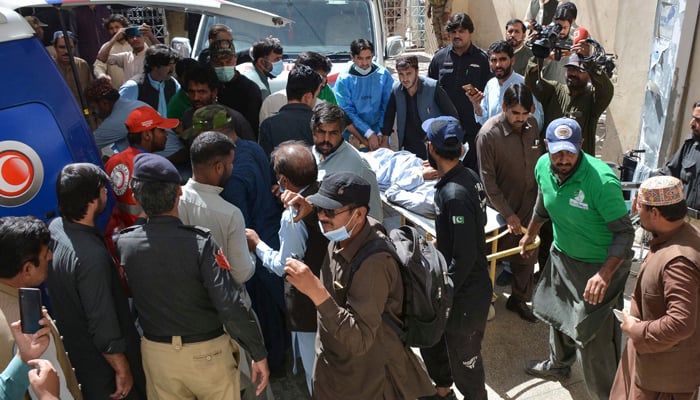 Volunteers move starchers carrying injured victims to a hospital in Quetta on October 7, 2021. — AFP