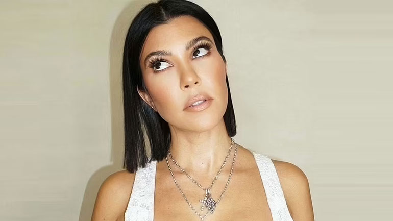 Kourtney Kardashian shows off her elegance in white tank top and satin navy shorts