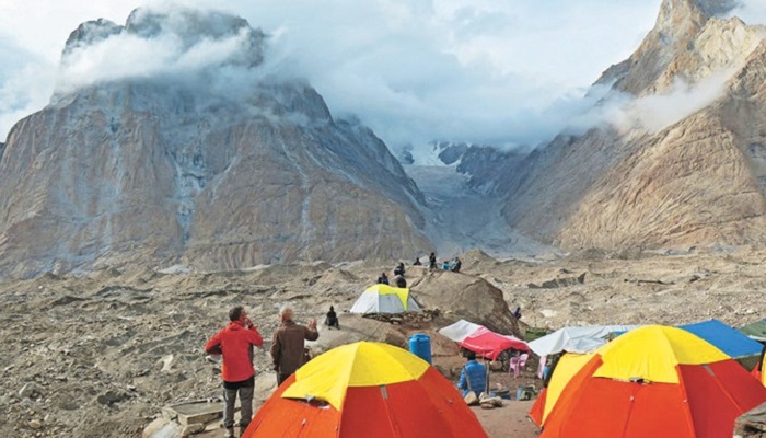 Foreign tourists and porters rest at a camping site above Baltoro glacier in the Karakoram range of Pakistan’s mountain northern Gilgit region. Photo: AFP