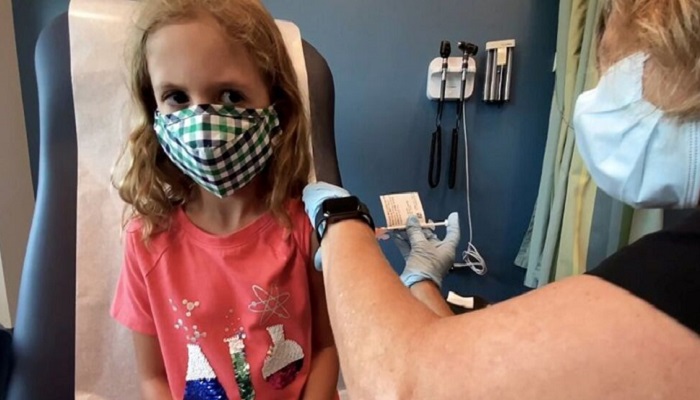 Lydia Melo, 7, is inoculated with one of two reduced 10 ug doses of the Pfizer BioNtech COVID-19 vaccine during a trial at Duke University in Durham, North Carolina September 28, 2021 in a still image from video. Video taken September 28, 2021. photo: Reuters