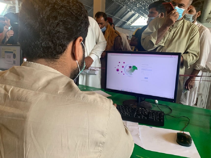 A data operator enters the information of people who have arrived at the vaccination center to get their coronavirus vaccine jab in Lahore, October 6, 2021. — Photo by authors