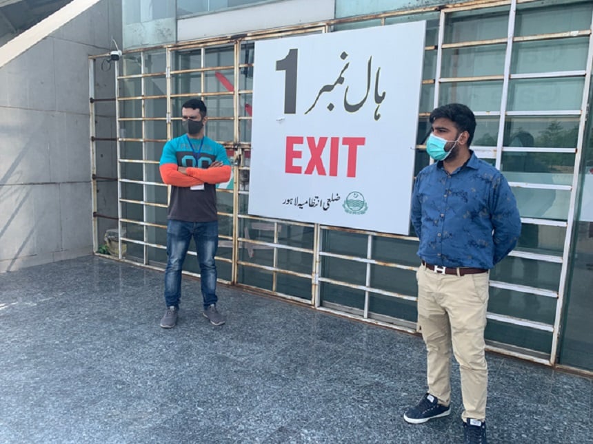 Saqib Baig, a health official, is standing outside the Expo Center in Lahore in order to catch those who try to leave the center without getting their vaccine dose in Lahore, October 6, 2021. — Photo by authors