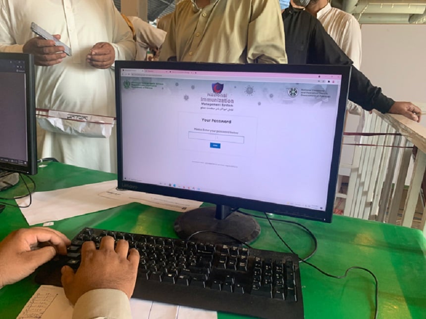 A data operator enters the information of people who have arrived at the vaccination center to get their coronavirus vaccine jab in Lahore, October 6, 2021. — Photo by authors