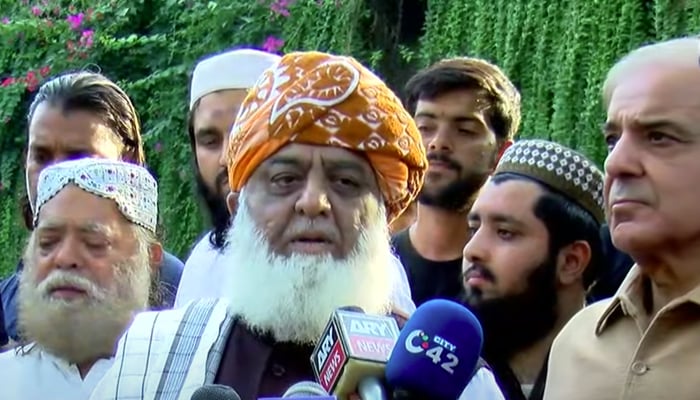 PDM chief Maulana Fazlur Rehman (centre) and Leader of the Opposition in the National Assembly Shahbaz Sharif (eight) addressing a press conference in Lahore on October 9, 2021. — YouTube/HumNewsLive