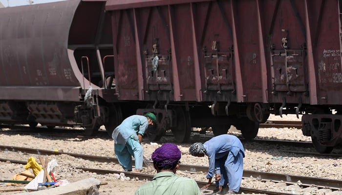 Railway employees busy in maintenance work on the track at Hyderabad Railway station in Hyderabad on August 23, 2021. — INP/File