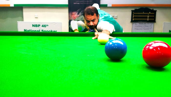 Mohammad Sajjad pocketing balls during the quarter final of National Snooker Championship in Karachi. — Photo by author