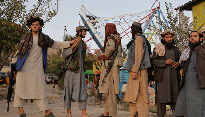 Taliban fighters look on as they take a day off to visit the amusement park at Kabuls Qargha reservoir, at the outskirts of Kabul, Afghanistan October 8, 2021. Picture taken October 8, 2021. — Reuters