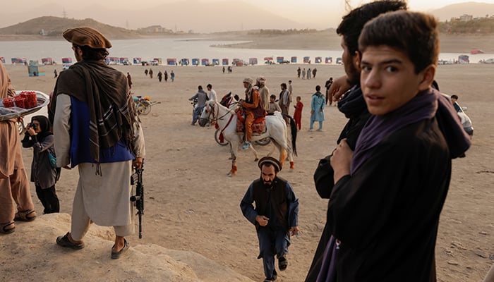 Taliban fighters look on as they take a day off to visit the amusement park at Kabuls Qargha reservoir, at the outskirts of Kabul, Afghanistan October 8, 2021. Picture taken October 8, 2021. — Reuters