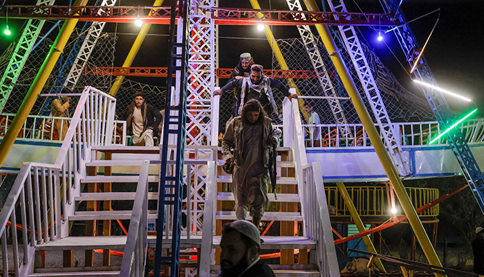 Taliban fighters walk down the stairs as they take a day off to visit the amusement park at Kabuls Qargha reservoir, at the outskirts of Kabul, Afghanistan October 9, 2021. Picture taken October 8, 2021. — Reuters