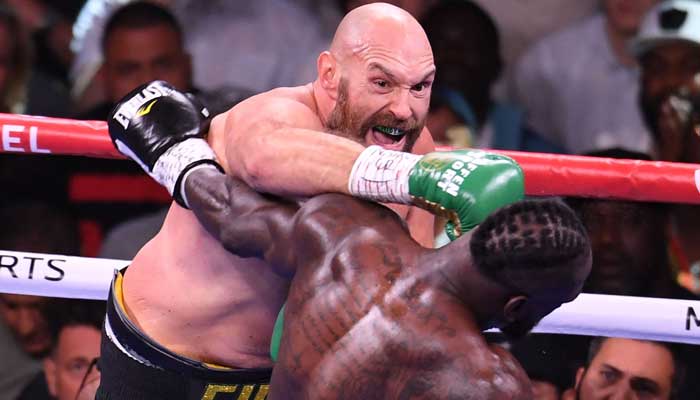 WBC heavyweight champion Tyson Fury of Great Britain (L) lands a punch on US challenger Deontay Wilder (R) in the third round fight for the WBC/Lineal Heavyweight title at the T-Mobile Arena in Las Vegas, Nevada, October 9, 2021. — Photo by Robyn Beck/AFP