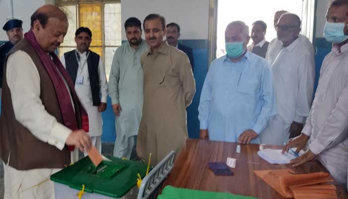 Azad Jammu and Kashmir President Barrister Sultan Mahmood Choudhry casting his ballet at a polling station in Thothal, in Mirpur, on October 10, 2021. — Twitter/PTI