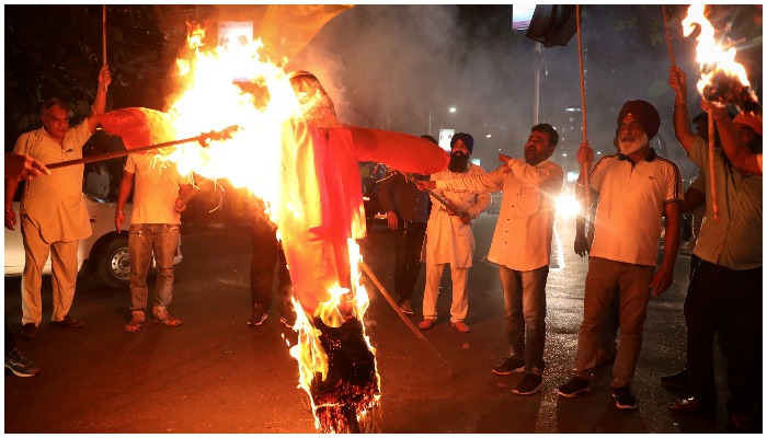 Protestors burn an effigy of Yogi Adityanath, Chief Minister of the northern state of Uttar Pradesh, during a protest after people were killed when a car linked to a federal minister ran over farmers protesting against controversial farm laws in Uttar Pradesh on Sunday, in Kolkata, India, October 4, 2021. Reuters/Rupak De Chowdhuri.