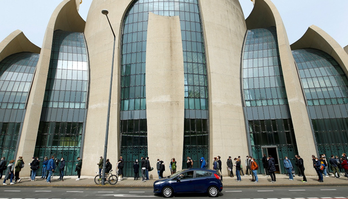 People queue in front of the Central Mosque in Ehrenfeld suburb, as they wait for a COVID-19 vaccination, amid the coronavirus disease (COVID-19) pandemic, in Cologne, Germany, May 8, 2021. — Reuters/File