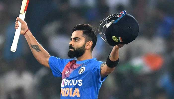 Virat Kohli raises his bat after scoring a century. Photo: AFP