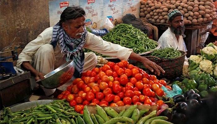 Men sell vegetables at their makeshift stalls at the Empress Market in Karachi, Pakistan. Photo: Reuters