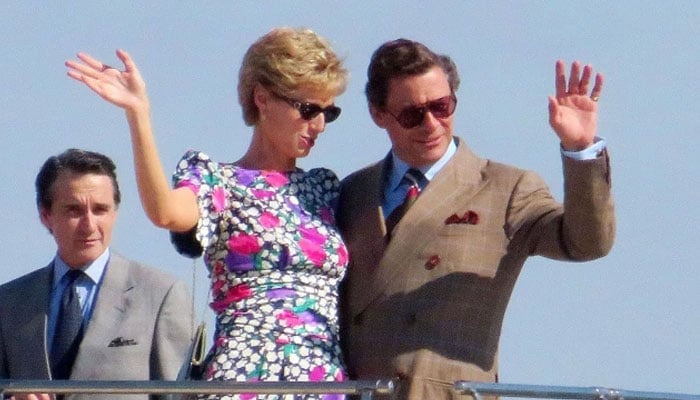 Elizabeth Debicki looking like a spitting image of Princess Diana as she can be seen waving with Dominic West’s Prince Charles